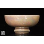 A miniature Ruskin Pottery footed bowl decorated in an all over pale pink lustre, impressed marks,