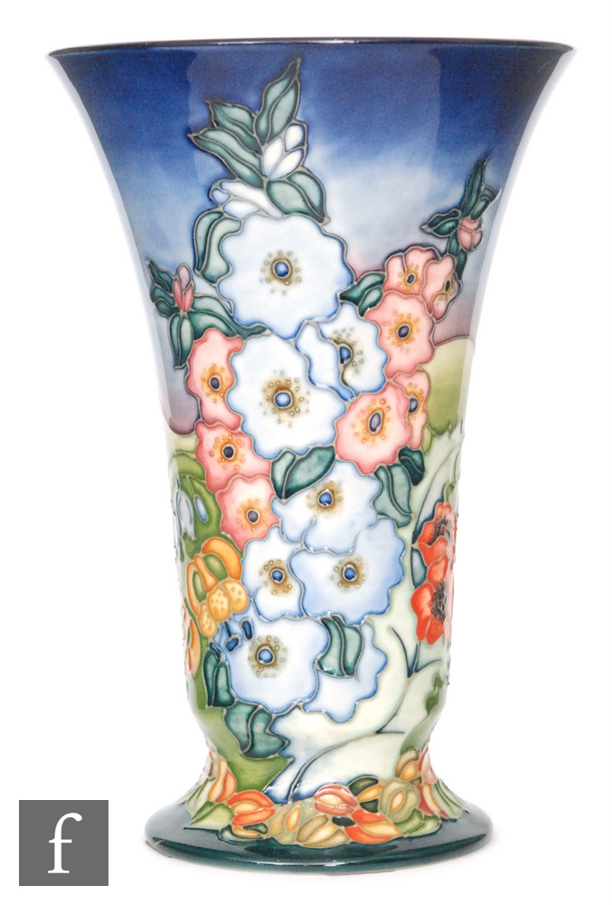 A large modern Moorcroft Pottery vase of footed and flared form decorated in the England pattern by