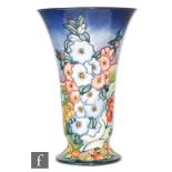 A large modern Moorcroft Pottery vase of footed and flared form decorated in the England pattern by