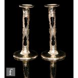 A pair of hallmarked silver and green glass candlesticks,