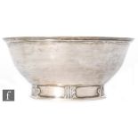 A white metal pedestal footed bowl of plain form with stylised decoration to foot rim,