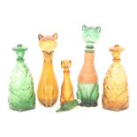 A group of five Continental novelty glass decanters, comprising two in the form of cats,