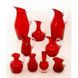 A group of later 20th Century Whitefriars glass jugs and vases, all in ruby,