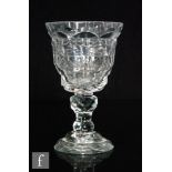 A late 18th Century goblet with a round funnel bowl heavily cut with repeat lozenges and flats