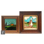 Two framed Art Nouveau tubelined tiles, the first depicting a Dutch girl in landscape, 15cm x 15cm,