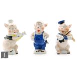 Three 1930s toothbrush holders modelled as the Three Little Pigs from the 1933 United Artists film,