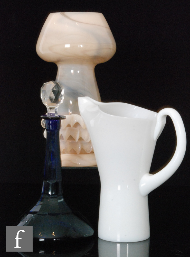 A post war white opalescent glass jug, possibly Holmegaard, of flared body with applied handle,