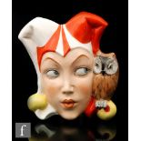A 1930s Czechoslovakian wall mask modelled as a female jester wearing a red and white hat and