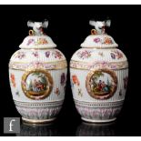 A pair of late 19th/early 20th Century Berlin porcelain vases and covers, each of ribbed ovoid from,