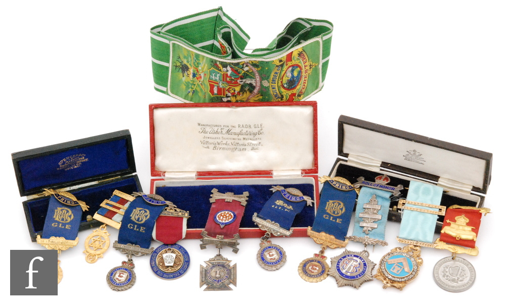 A 19th Century Masonic jewel with enamelled centre and paste set border with ribbon in recognition