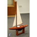 A 1950s and 1960s single masted wooden pond yacht on stand,