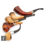 A collection of five early 20th Century Meerschaum pipes of plain form,