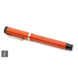 A Parker Duofold fountain pen, orange case.