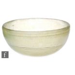 Roman 2nd to 4th Century AD - A pale green glass shallow bowl with traces of iridescence and