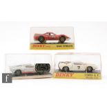 Three boxed Dinky Toys diecast model cars, #132 Ford 40RV in silver with red interior,