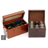 A 19th Century mahogany cased apothecary cabinet containing six bottles with one later blue example,