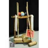 A mid 20th Century croquet set, the wooden stand complete with four A.