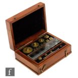 A late 19th Century mahogany cased set of brass weights and measures,