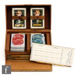 A 1930s leather cased bridge set fitted with two packs of Leyland Motors pictorial cards and four