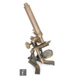 An early 20th Century brass compound microscope on a cast black painted base, height 37cm.