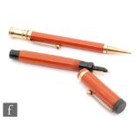 A Parker Duofold Junior fountain pen, orange with 14ct gold N nib and a matching propelling pencil.