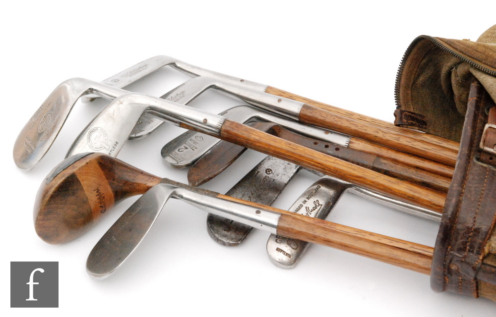 A collection of ten early 20th Century hickory shafted golf clubs,