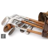 A collection of ten early 20th Century hickory shafted golf clubs,
