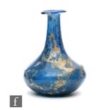 Roman 2nd to 4th Century AD - A miniature blue glass flask, the slender neck to an ovoid base,