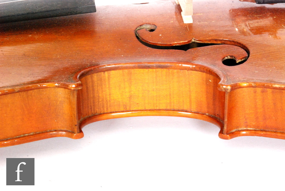 A 1920 to 1930s violin, the reverse stamped Stainer, length of back 35.5cm and with a bow, cased. - Image 11 of 17