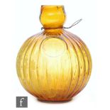 A French amber Unic glass fire grenade of ribbed form,