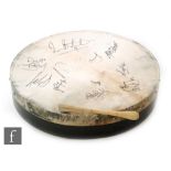 A skin covered drum signed in black felt pen by members of the Irish folk band the Dubliners,