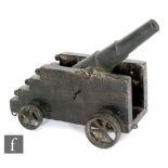A late 19th to early 20th Century bronze Howitzer type canon on stepped wooden carriage and spoked