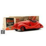 A Schuco Examico 4001 tinplate clockwork car in red with maroon seats, boxed with instructions, S/D.