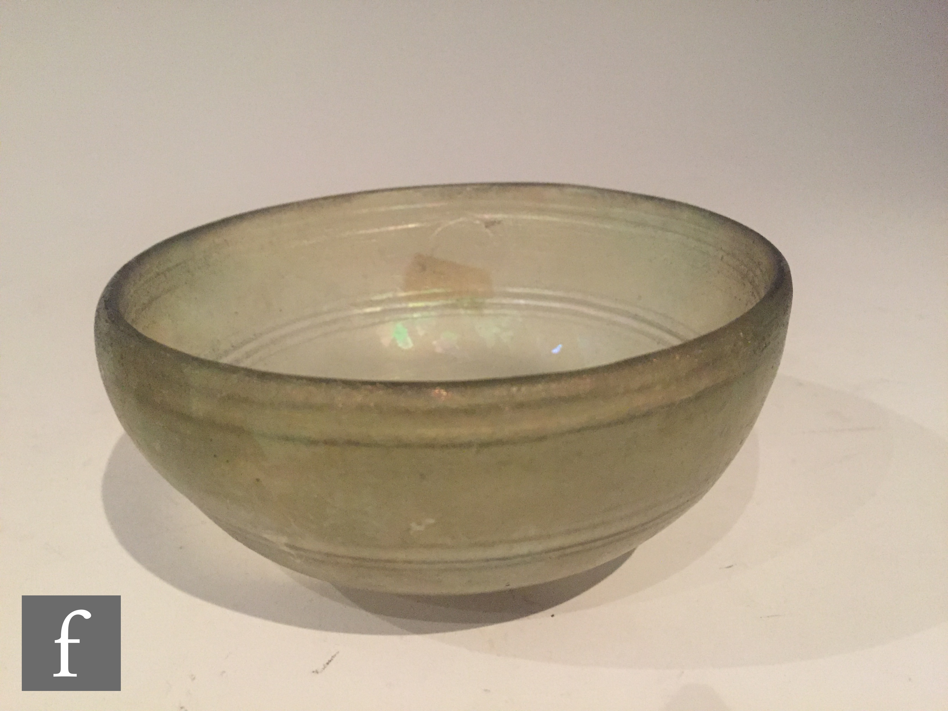 Roman 2nd to 4th Century AD - A pale green glass shallow bowl with traces of iridescence and - Image 2 of 5