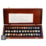 A cased set of forty two enamelled Heraldic emblems of the Kings and Queens of England with key to