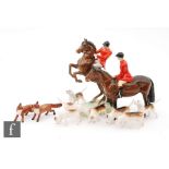 A Beswick hunting group comprising a model 868 rider on horseback, 868, a model 1501 huntsman,