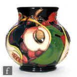 A Moorcroft Pottery vase in the Queen's Choice pattern, of footed squat ovoid form with everted rim,