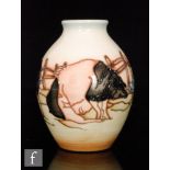 A Moorcroft Pottery vase in the Limousin Pig pattern designed by Kerry Goodwin, of footed ovoid form