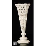 A large late 19th Century parian spill vase, the flared body with foliate scroll pierced panels