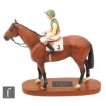 A Beswick Connoisseur model of Nijinsky with Lester Piggott up, mounted to an oval wooden plinth,