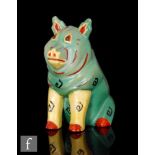 An early 20th Century Louis Wain Lucky Pig figure modelled as a seated pig, painted in green,