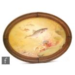 An early 20th Century handpainted oval porcelain plaque, decorated with sturgeon and seatrout in a