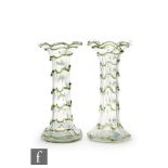 A pair of late 19th Century fluted glass vases with squat base, cylindrical column and everted