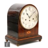 An Edwardian line inlaid mahogany domed mantle clock, with eight day striking movement, circular