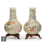 A pair of late 19th Century posy vases of globe and shaft form with gilded and enamelled butterflies