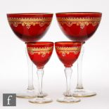 Two early 20th Century Venetian drinking glasses, each with an ovoid ruby glass bowls with a