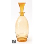 A Stuart & Sons Art Deco amber glass decanter of ovoid form with a matched inverted conical stopper,