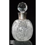 An early 20th Century clear crystal scent bottle of globular form with a pillar moulded body with