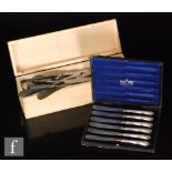 Eighteen Sterling silver handled dinner and dessert knives with four silver handled button hooks,