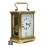 A late 19th to early 20th Century brass and bevelled glass cased carriage clock, with subsidiary